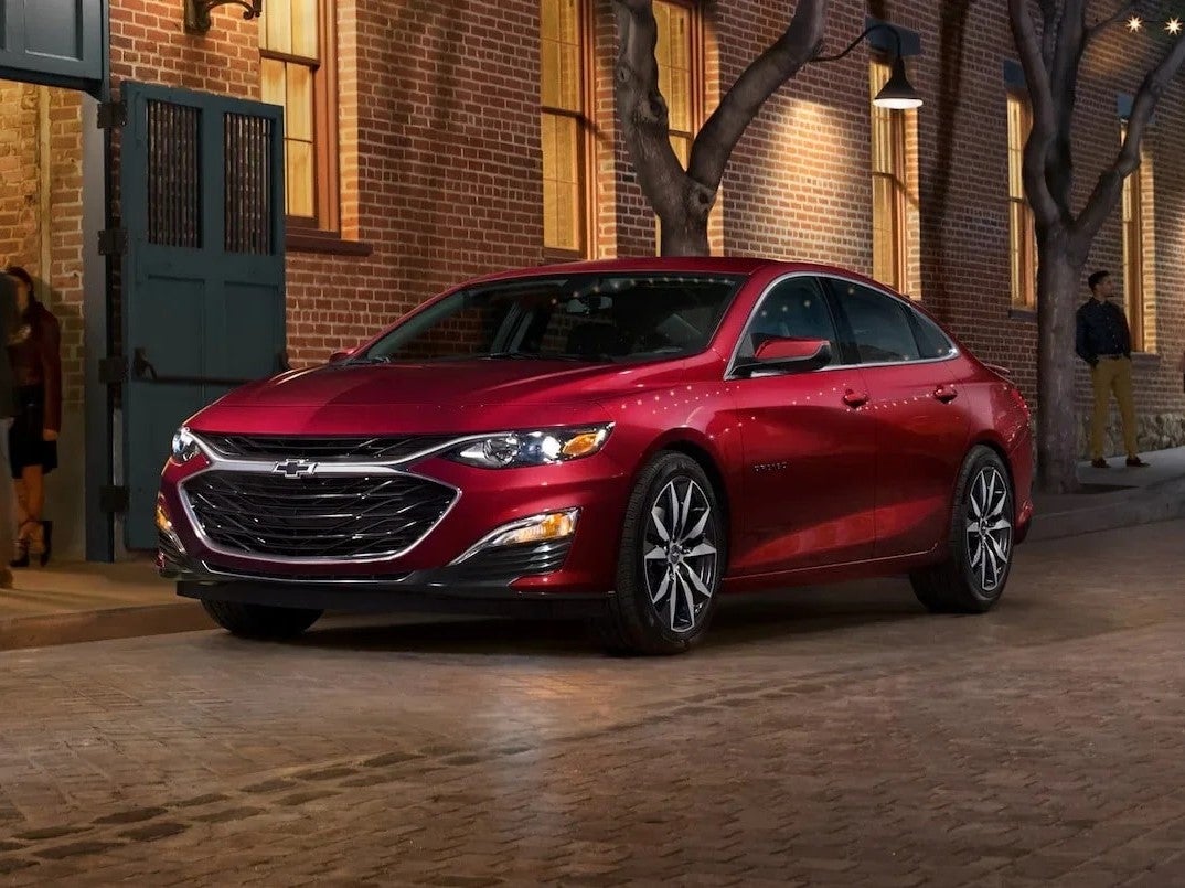 A red 2022 Chevy Malibu parked at night