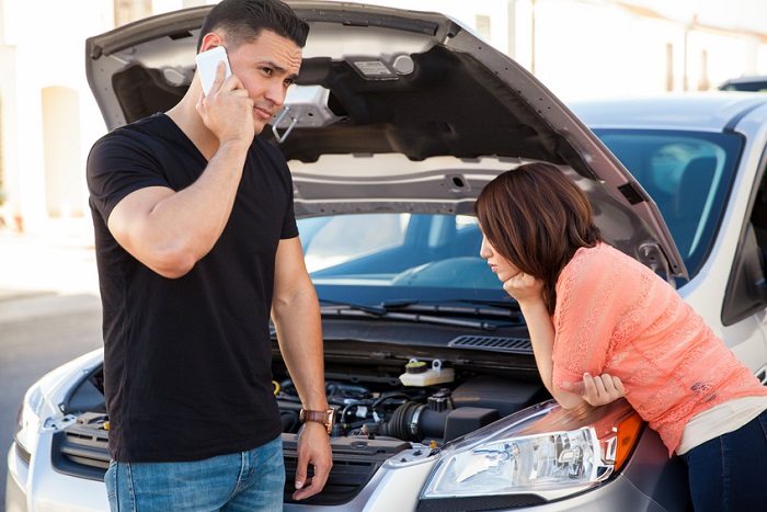 Couple near broken-down car