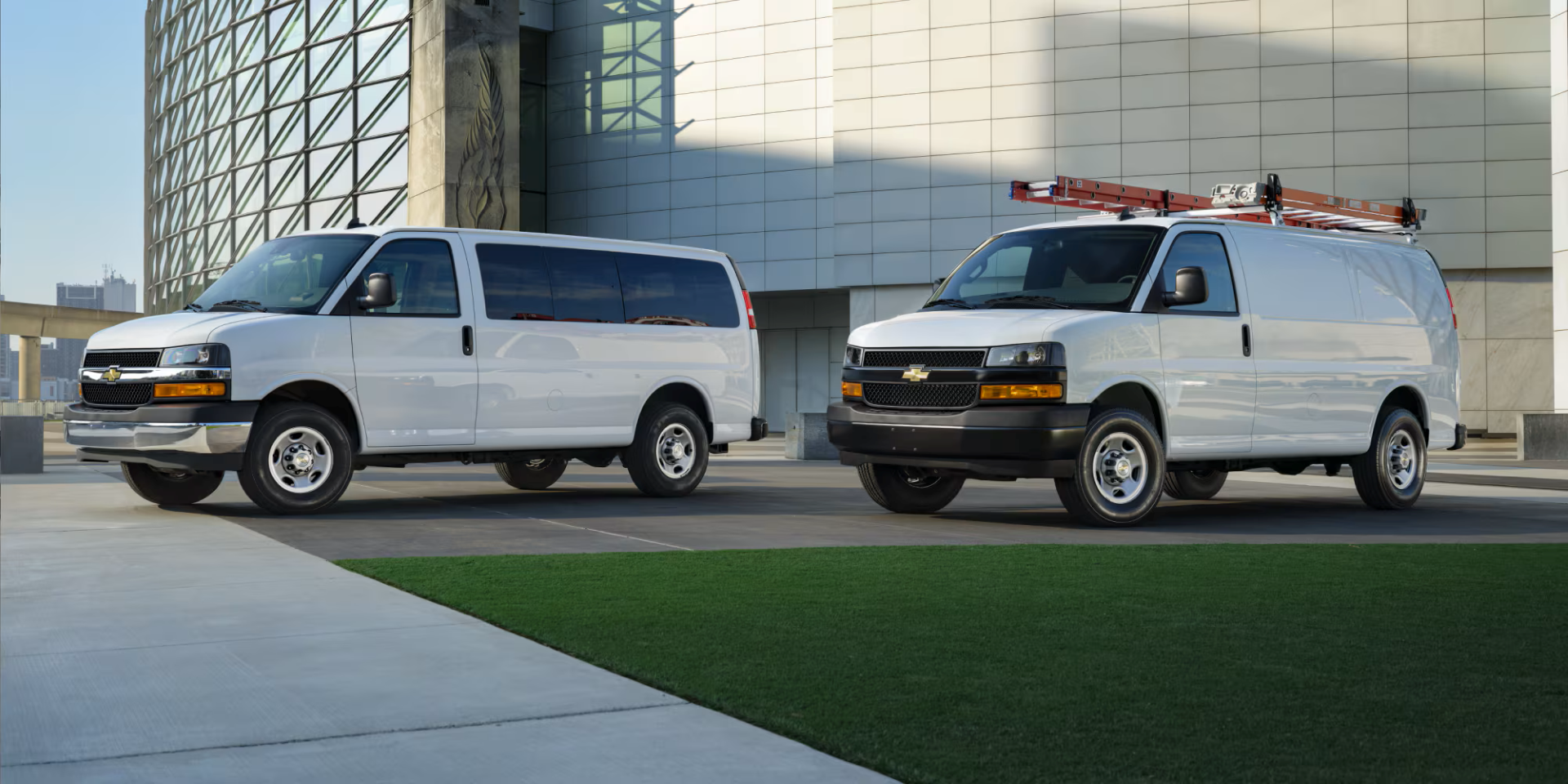 Two 2026 Chevy Express vans parked